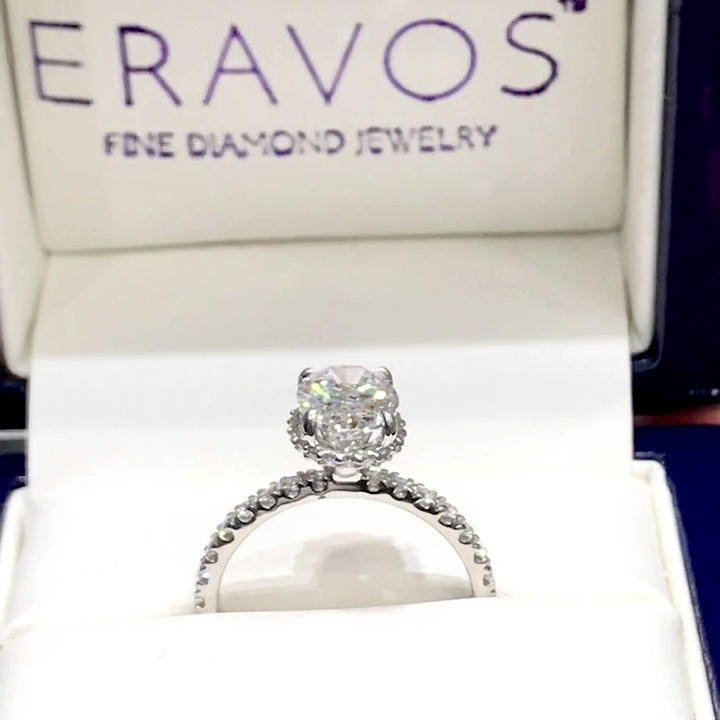 18kt White Gold Engagement Ring with 2 carat lab diamond at the center (Color: D | Clarity: VS1 | Oval Cut) and natural E / VVS grade Setting Diamonds. Hidden Halo Setting with Diamonds on the Shank.